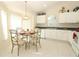 Sunny breakfast nook featuring a round glass table, stylish chairs, and white cabinetry at 8093 Indian Creek Blvd, Kissimmee, FL 34747