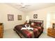 Comfortable main bedroom with a bed dressed in rich colors and decorative pillows plus matching nightstands at 8093 Indian Creek Blvd, Kissimmee, FL 34747