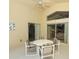 Enclosed patio featuring tile flooring, sliding glass doors and a table with four chairs at 8093 Indian Creek Blvd, Kissimmee, FL 34747