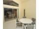 Enclosed patio featuring tile flooring, sliding glass doors and a table with four chairs at 8093 Indian Creek Blvd, Kissimmee, FL 34747
