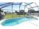 Sparkling screened-in pool and spa offer a relaxing outdoor space with lovely views at 8093 Indian Creek Blvd, Kissimmee, FL 34747