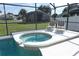 Close up of relaxing in-ground spa adjacent to the pool and screened-in patio at 8093 Indian Creek Blvd, Kissimmee, FL 34747