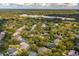 An aerial perspective featuring homes nestled amid lush trees and serene bodies of water at 831 Royalwood Ln, Oviedo, FL 32765