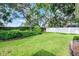 Well-maintained backyard features lush green grass, manicured hedges, and a white vinyl fence at 831 Royalwood Ln, Oviedo, FL 32765