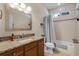 Well-lit bathroom with granite countertop, tiled shower with a bathtub, and tiled floors at 831 Royalwood Ln, Oviedo, FL 32765