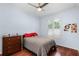 Bedroom with light blue walls, ceiling fan, hardwood floors and plantation shutters at 831 Royalwood Ln, Oviedo, FL 32765