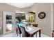 Dining area overlooking the pool area with access door and bright natural light at 831 Royalwood Ln, Oviedo, FL 32765