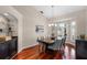Bright dining room featuring a dark wood table, seating for six, and elegant chandelier lighting at 831 Royalwood Ln, Oviedo, FL 32765