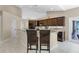 Kitchen featuring a breakfast bar, dark cabinets, granite countertops, and stainless appliances at 831 Royalwood Ln, Oviedo, FL 32765