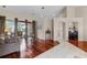 Bright living room with hardwood floors, light neutral walls, and access to the outdoor living space at 831 Royalwood Ln, Oviedo, FL 32765