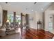 Living room with hardwood floors, sliding doors, and plenty of natural light at 831 Royalwood Ln, Oviedo, FL 32765