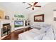 Comfortable living room featuring a fireplace, ceiling fan, and a large sectional sofa at 831 Royalwood Ln, Oviedo, FL 32765