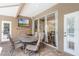Cozy covered patio perfect for outdoor dining, complete with TV and access to the pool at 831 Royalwood Ln, Oviedo, FL 32765