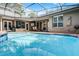 Enclosed pool with a screened-in patio area with outdoor seating and entertainment area at 831 Royalwood Ln, Oviedo, FL 32765