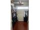 A well-organized walk-in closet featuring hanging clothes, shelving, and hardwood floors offering space for storage at 831 Royalwood Ln, Oviedo, FL 32765