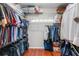 Organized walk-in closet featuring wood floors, custom shelving, and ample storage space at 831 Royalwood Ln, Oviedo, FL 32765