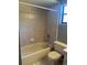 Bathroom featuring a shower-tub combo, tile flooring, and small window at 1050 Reading Ct, Winter Park, FL 32792
