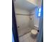 Bathroom featuring white tile shower, toilet and flooring at 1050 Reading Ct, Winter Park, FL 32792