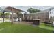 Backyard featuring pergola, seating and artificial turf at 1078 Aaron Dr, Deltona, FL 32725