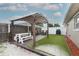 Backyard featuring pergola, seating and artificial turf at 1078 Aaron Dr, Deltona, FL 32725