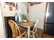 Bright dining area features a table set for four near a window and Coca-Cola themed decor at 1078 Aaron Dr, Deltona, FL 32725