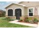 Inviting entrance with stone accents, colorful landscaping, and an American flag at 1078 Aaron Dr, Deltona, FL 32725