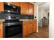 Well-equipped kitchen featuring stainless steel appliances, granite countertops, and wooden cabinetry at 1078 Aaron Dr, Deltona, FL 32725