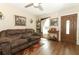 Comfortable living room with a brown sofa, wood-look floors, and natural light at 1078 Aaron Dr, Deltona, FL 32725