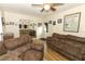Comfortable living room featuring plush sofas, mirrored wall, and ceiling fan at 1078 Aaron Dr, Deltona, FL 32725
