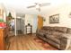 Cozy living room featuring wood-look floors, a ceiling fan and comfortable furnishings at 1078 Aaron Dr, Deltona, FL 32725