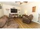 Inviting living room with brown sofa, accent chair, and a view of the backyard at 1078 Aaron Dr, Deltona, FL 32725