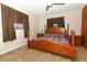 Cozy main bedroom with a wooden bed frame, brown curtains, and a ceiling fan at 1078 Aaron Dr, Deltona, FL 32725