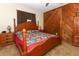 Comfortable main bedroom featuring a wooden bed frame and rustic wood accent wall at 1078 Aaron Dr, Deltona, FL 32725