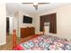 Spacious main bedroom featuring a wooden dresser, ceiling fan, and a wall-mounted television at 1078 Aaron Dr, Deltona, FL 32725