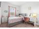 Bright bedroom features a plush bed, charming decor, and a functional desk area at 11054 Hanlon Terrace Aly, Winter Garden, FL 34787