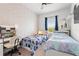 Charming bedroom with two twin beds, a desk, and a window, offering a bright and inviting space at 11054 Hanlon Terrace Aly, Winter Garden, FL 34787