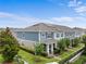 Attractive townhomes feature lush landscaping, manicured lawns, and appealing architectural details at 11054 Hanlon Terrace Aly, Winter Garden, FL 34787