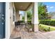 Inviting front porch with stone flooring and outdoor seating, perfect for relaxing at 11054 Hanlon Terrace Aly, Winter Garden, FL 34787