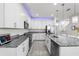 Modern kitchen featuring white cabinetry, stainless steel appliances, and granite countertops at 11054 Hanlon Terrace Aly, Winter Garden, FL 34787