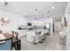 Open-concept kitchen with white cabinets, a large island, stainless steel appliances, and bar stool seating at 11054 Hanlon Terrace Aly, Winter Garden, FL 34787