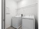 Bright laundry room with a white washer and dryer, and a wire shelf for storage at 11054 Hanlon Terrace Aly, Winter Garden, FL 34787
