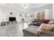 Bright living room with a gray sectional sofa, round coffee table, and sliding glass doors to the outside at 11054 Hanlon Terrace Aly, Winter Garden, FL 34787