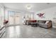 Spacious living room featuring a gray sectional sofa, modern art, and sliding glass doors leading to the exterior at 11054 Hanlon Terrace Aly, Winter Garden, FL 34787