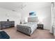 Comfortable main bedroom with a tufted headboard bed, neutral tones, and bedside tables with lamps at 11054 Hanlon Terrace Aly, Winter Garden, FL 34787