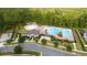 Aerial view of a community pool with a clubhouse, pergola, and basketball court surrounded by lush green landscaping at 11054 Hanlon Terrace Aly, Winter Garden, FL 34787
