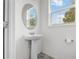 Clean powder room with pedestal sink, neutral walls, and bright lighting for a modern, fresh feel at 11054 Hanlon Terrace Aly, Winter Garden, FL 34787