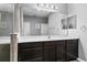 Spacious bathroom featuring a walk-in shower, dark wood cabinets, and a modern vanity at 12679 Calderdale Ave, Windermere, FL 34786