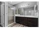 Spacious bathroom featuring a walk-in shower, dark wood cabinets, and a modern vanity at 12679 Calderdale Ave, Windermere, FL 34786