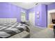 Cozy bedroom with violet walls, neutral carpet, a desk setting, and double door closet at 12679 Calderdale Ave, Windermere, FL 34786