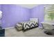Cozy bedroom featuring an upholstered headboard, gray carpet, and a comfortable bed with a patterned duvet at 12679 Calderdale Ave, Windermere, FL 34786